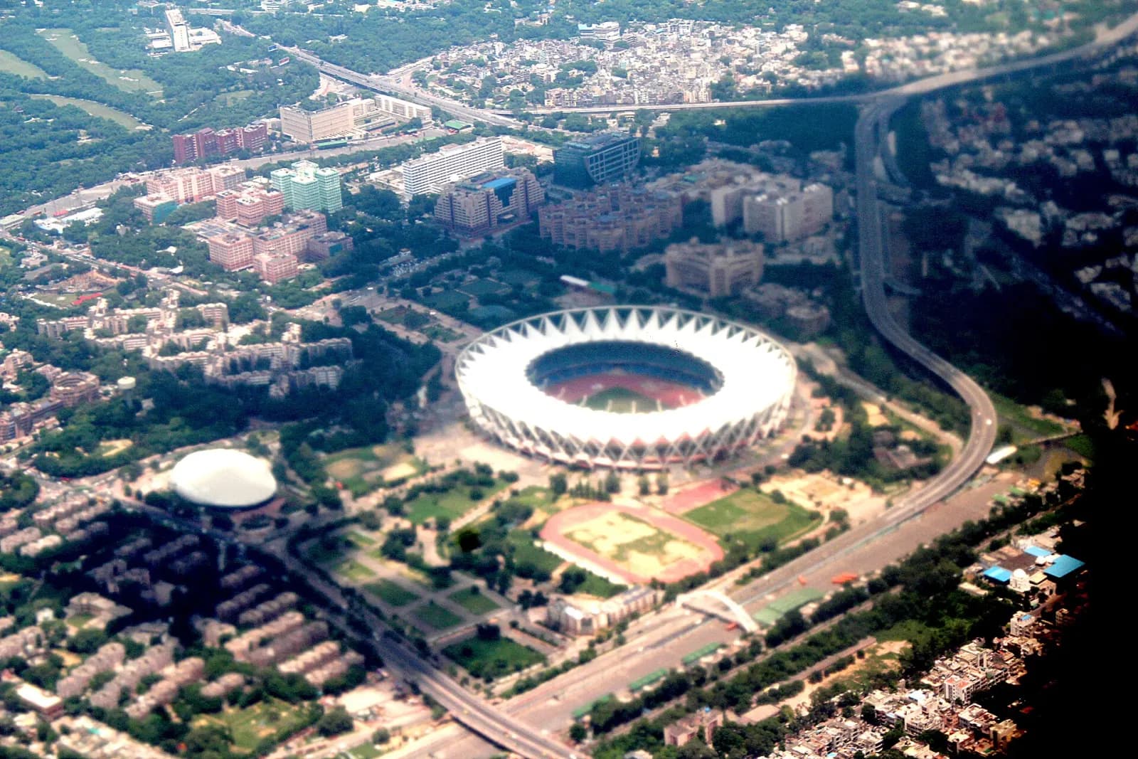 Aerial view of a Delhi stadium, flyovers and the roads around them